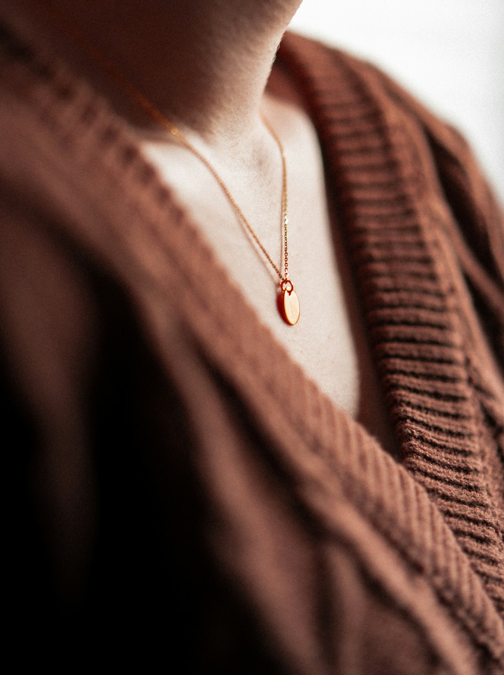 a close up of a person wearing a necklace