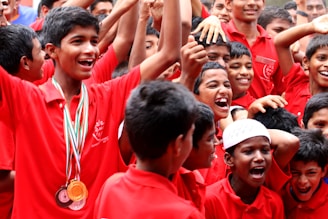 a group of young boys standing next to each other