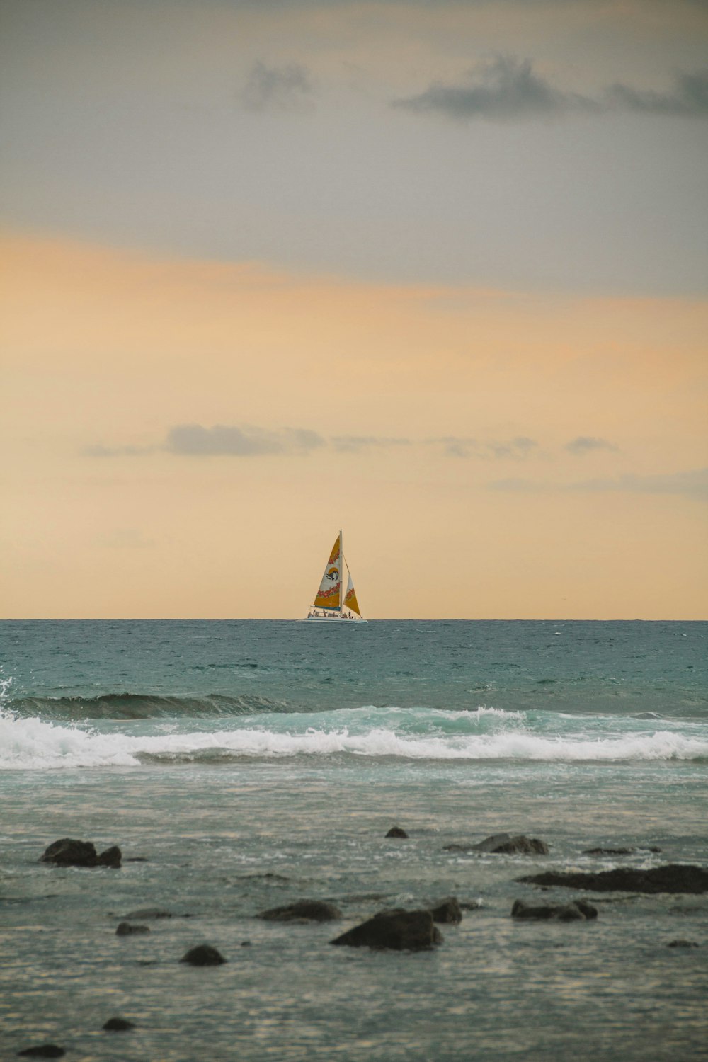 a sailboat is in the distance on the ocean