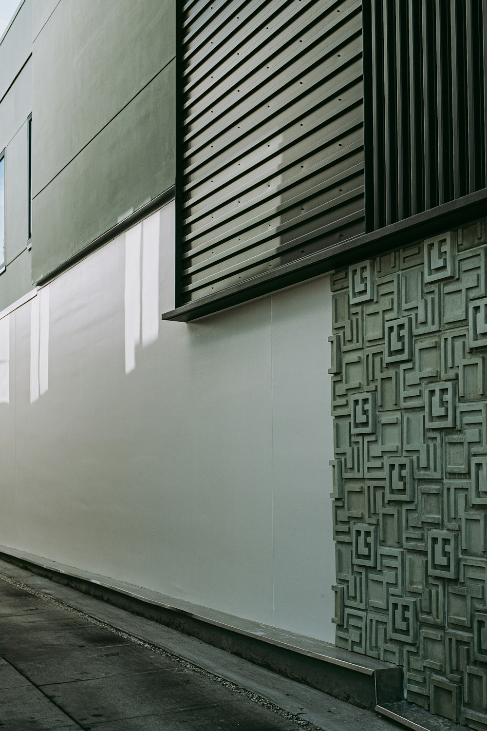 a person walking down a street next to a tall building