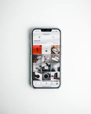 A smartphone showing social media ads with vibrant graphics and clear calls to action.