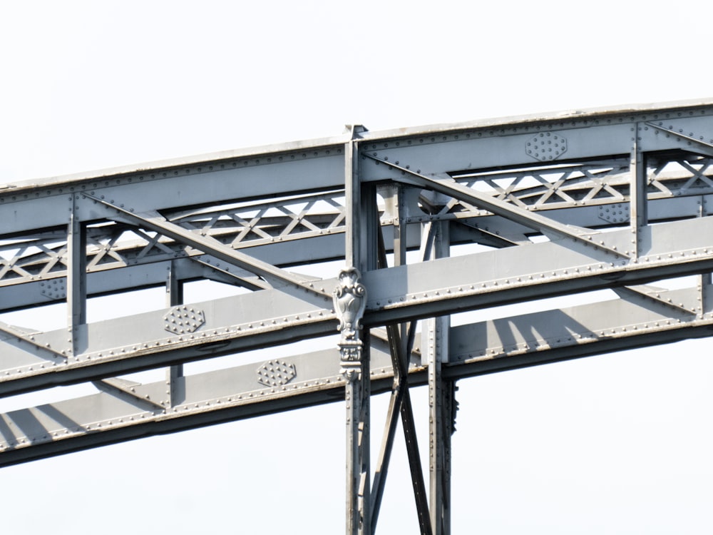 a close up of a metal structure with a sky background