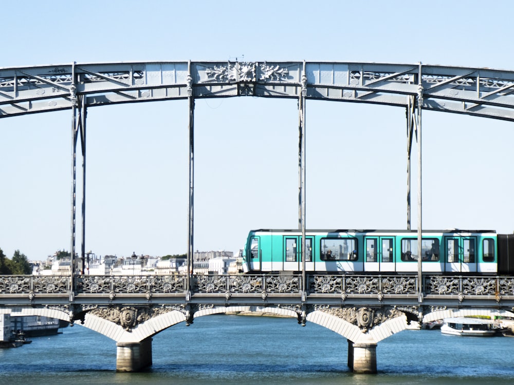 a train crossing a bridge over a body of water