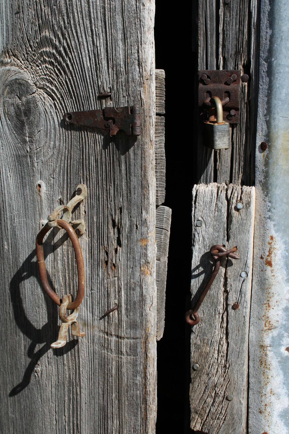 a close up of a wooden door with metal handles