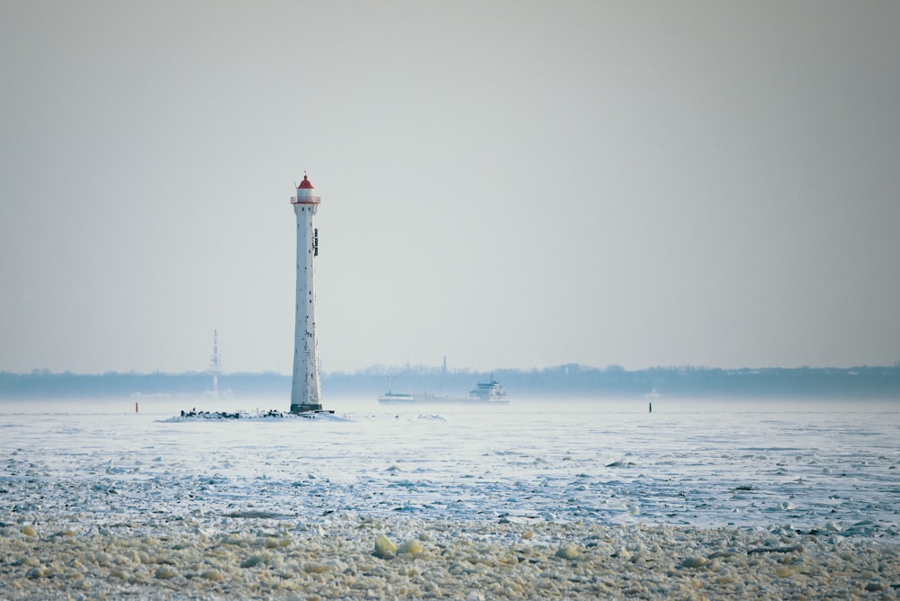 a light house in the middle of a body of water