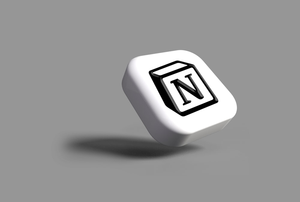 a white dice with a black n on it