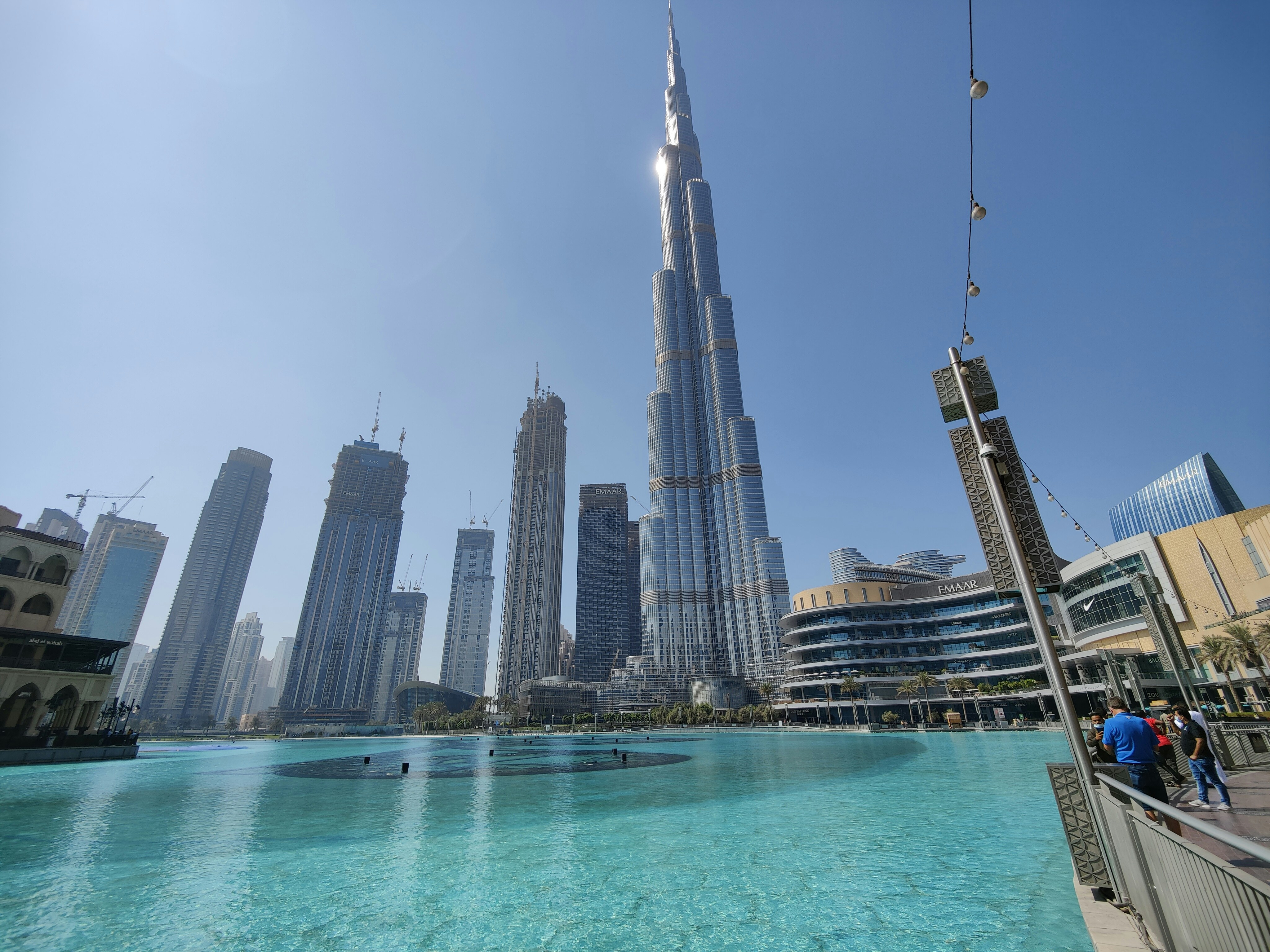 Crystal clear swimming pool installation at Dubai villa, sunlit outdoor luxury setting