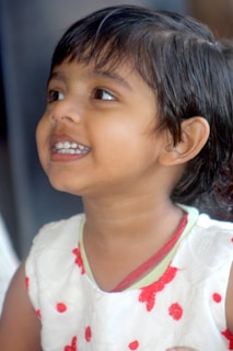 A cheerful child wearing a bright outfit and shoes.