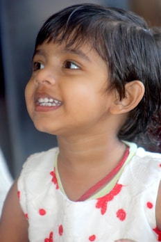A cheerful child wearing a bright outfit and shoes.