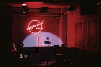 a stage set up for a concert with a neon sign