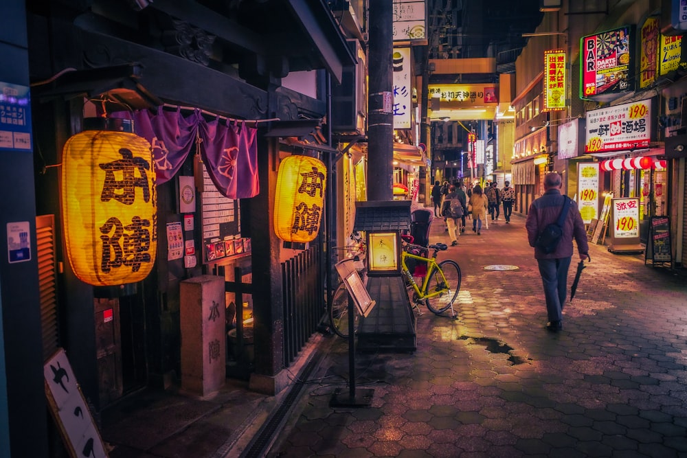 a person walking down a street at night