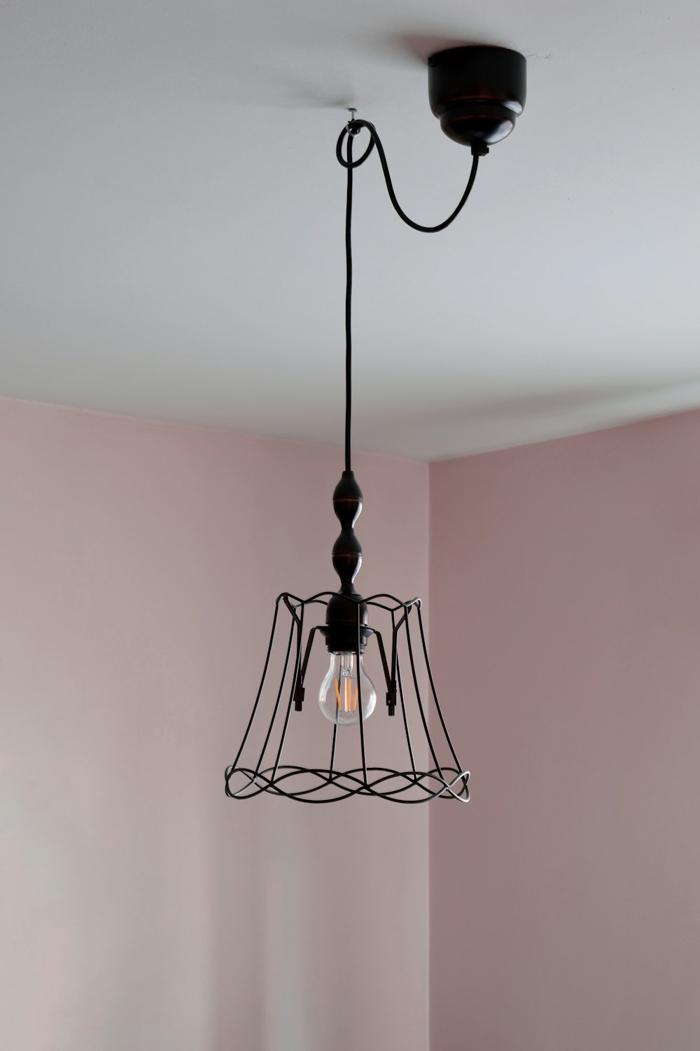 a light hanging from a ceiling in a room