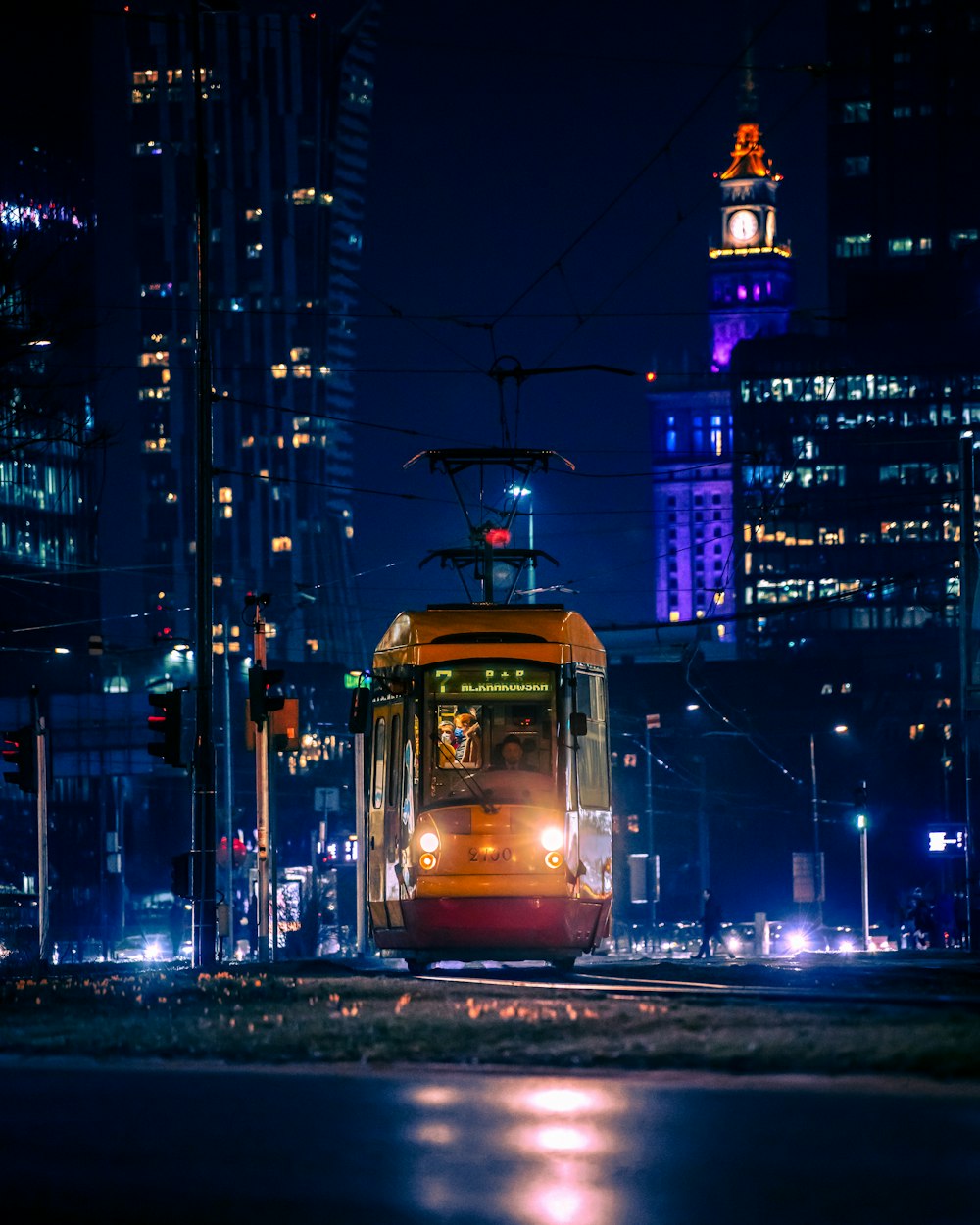a trolley car on a city street at night