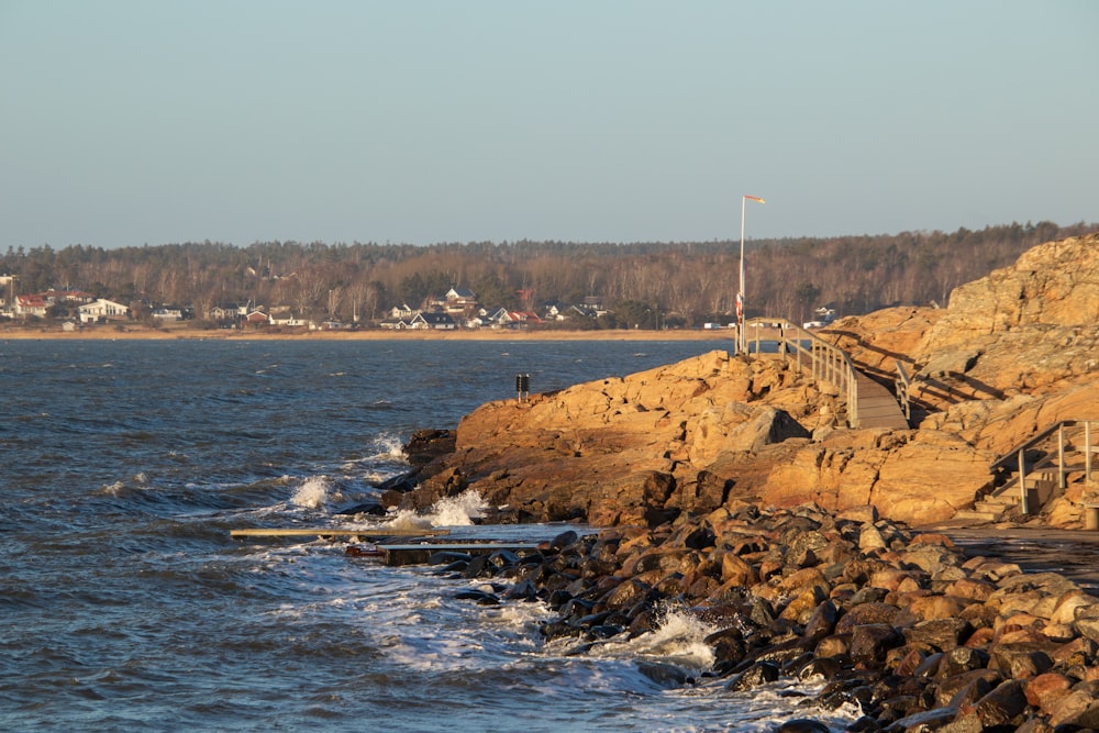 a body of water with a rocky shore next to it