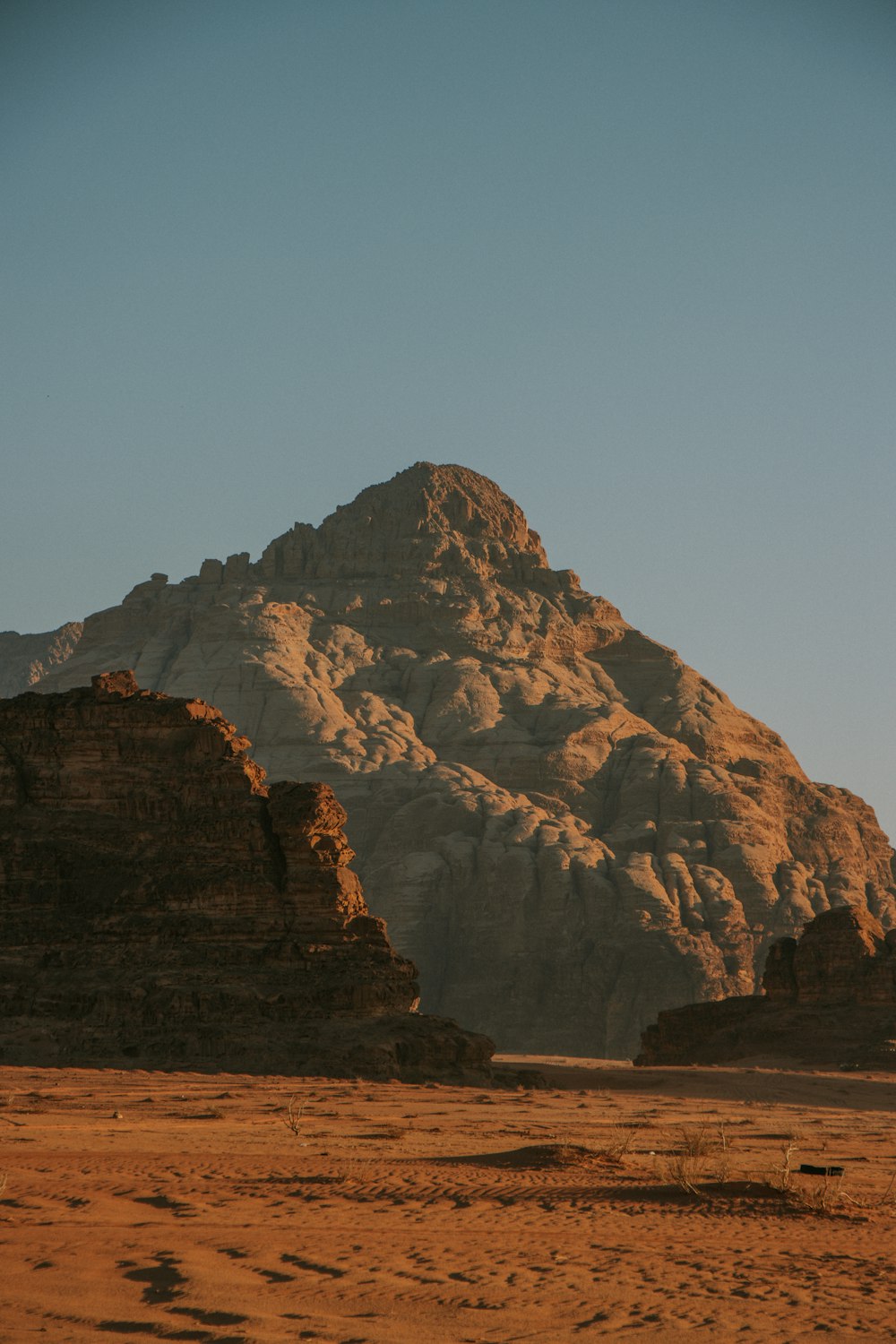 a large mountain in the middle of a desert