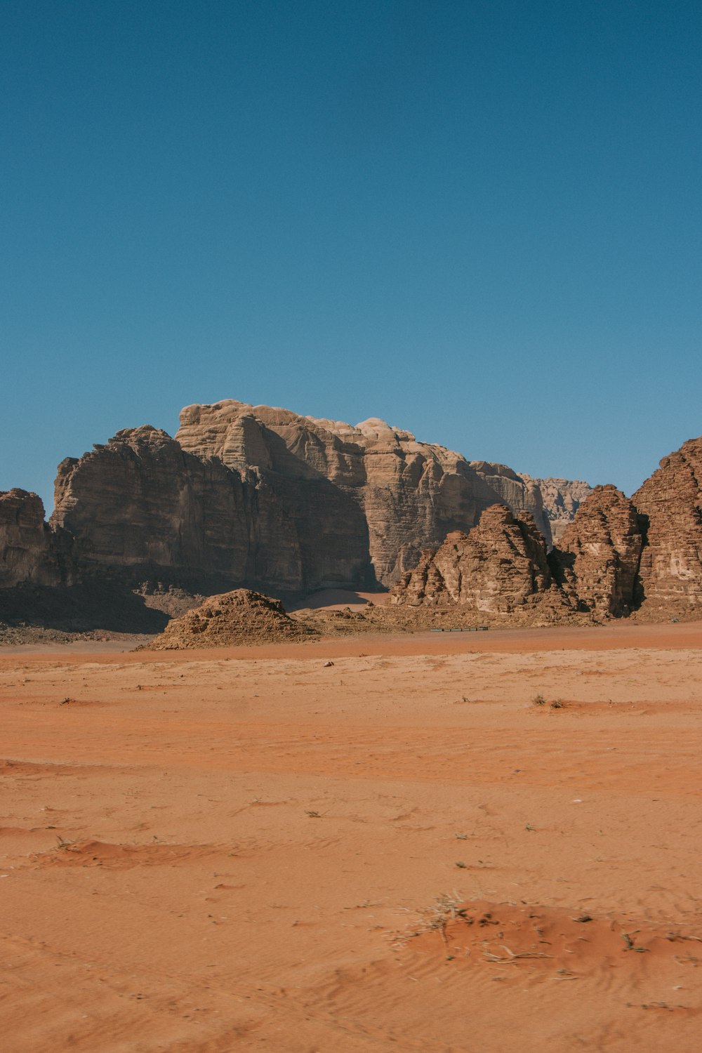 a desert area with a mountain range in the background