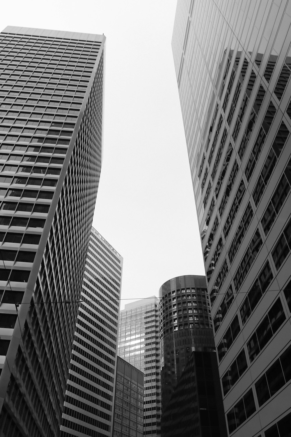 a black and white photo of tall buildings