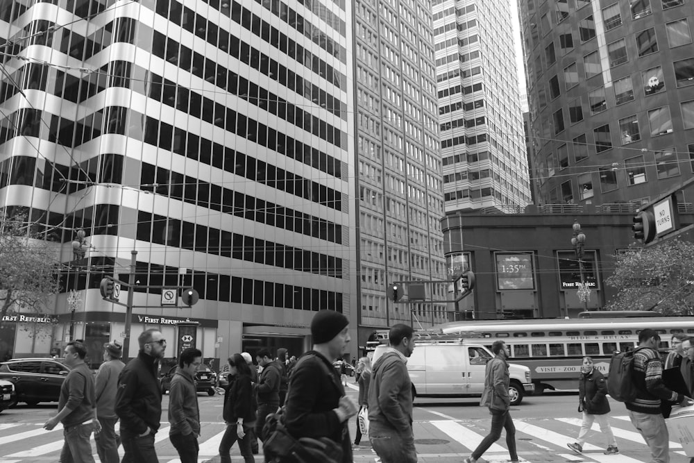 a group of people walking across a cross walk