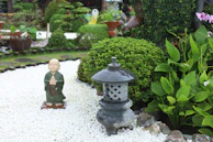 A peaceful temple courtyard with blooming flowers and a quiet meditation space