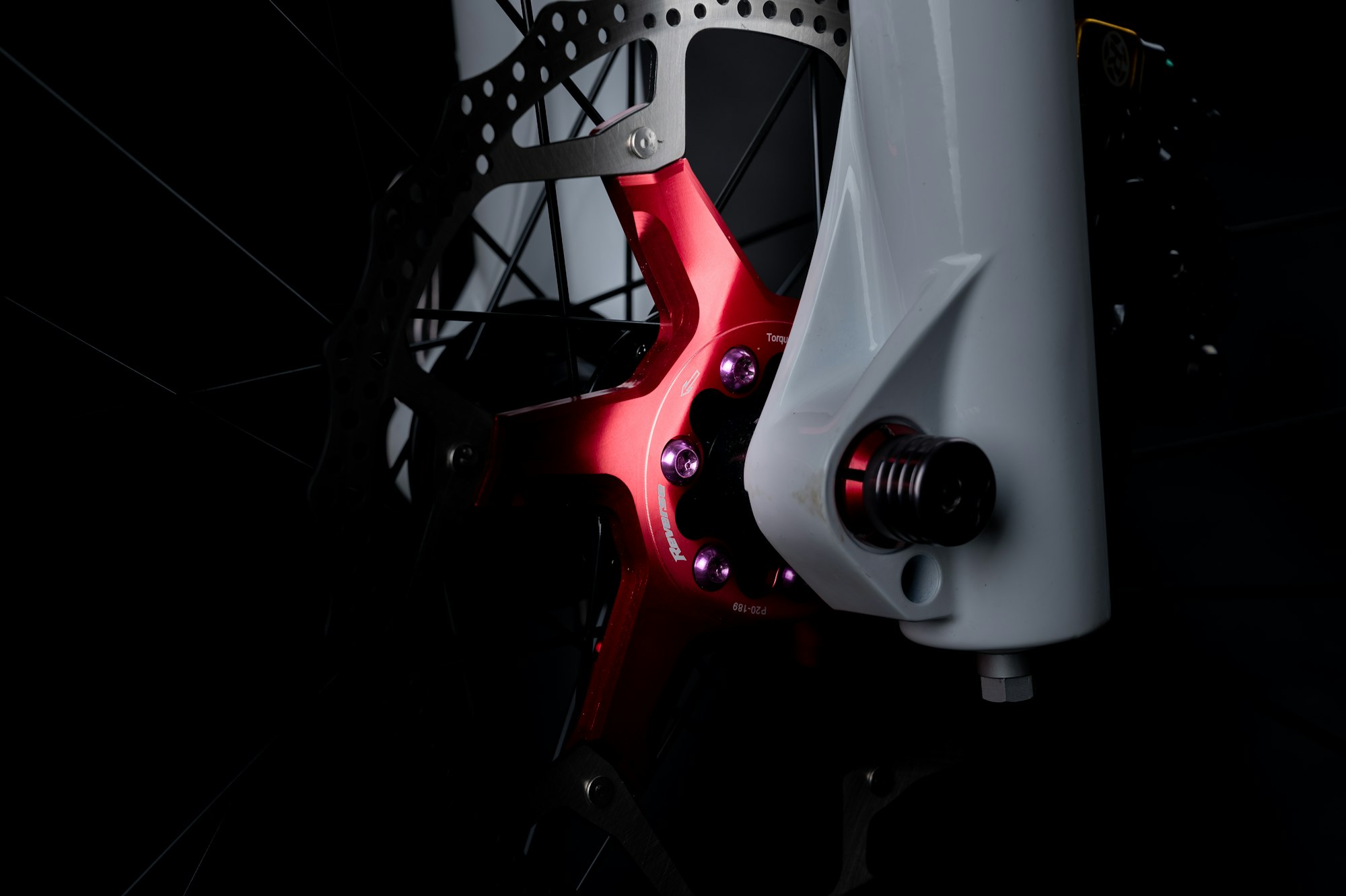 Mountain bike red disc brake detail in the dark