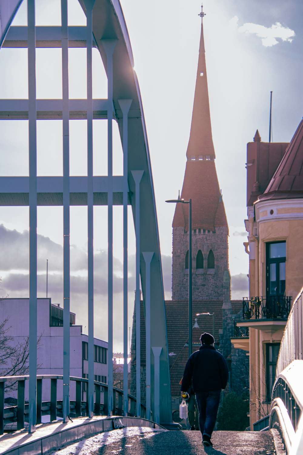 a man walking down a street next to a tall building