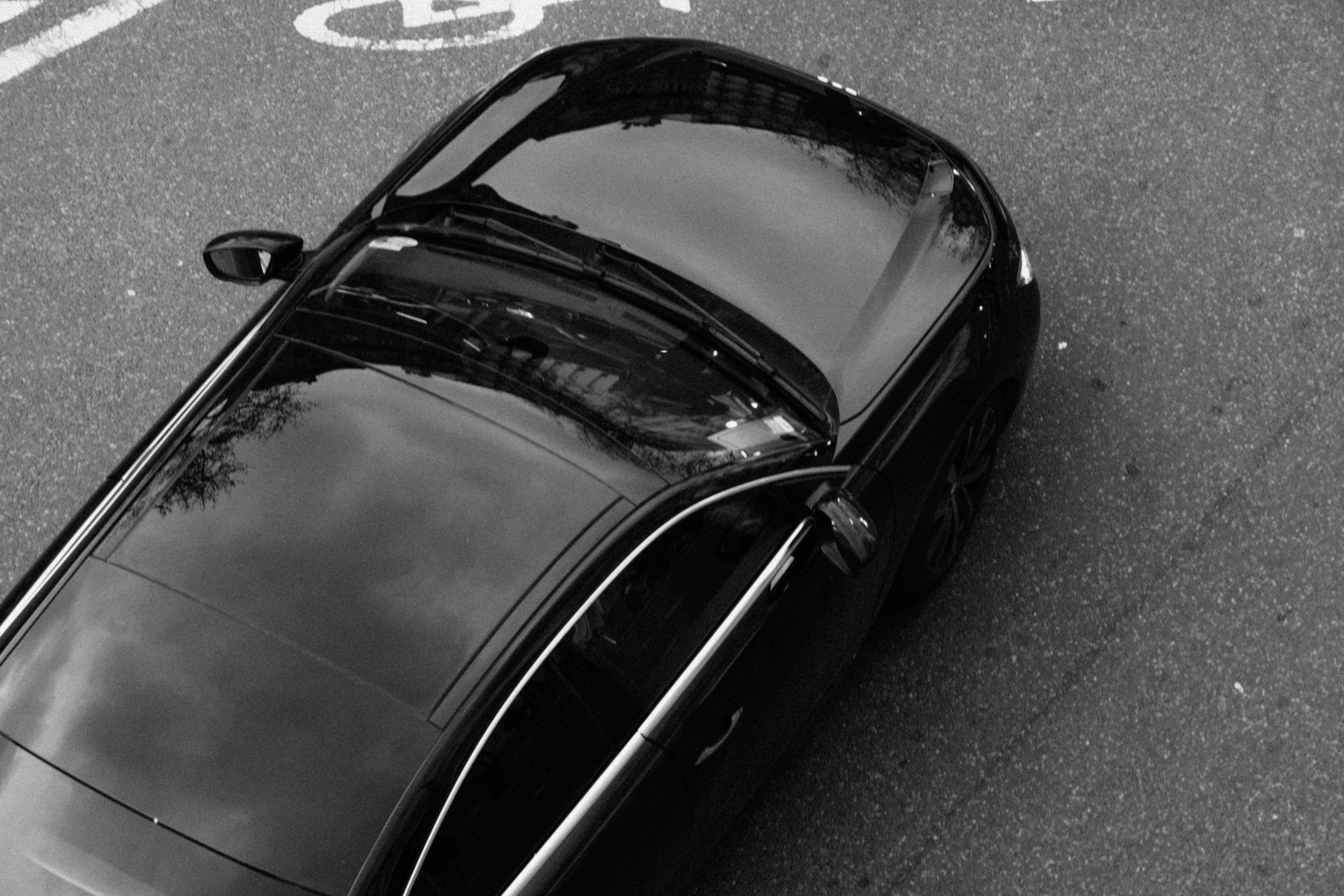 a black car parked on the side of the road