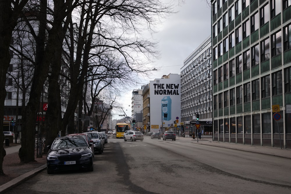 a city street lined with tall buildings and parked cars