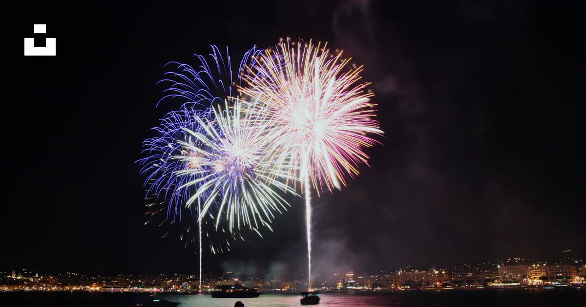 Firework Popping Rocks A person standing on a rock looking at fireworks photo β Free Fireworks ...