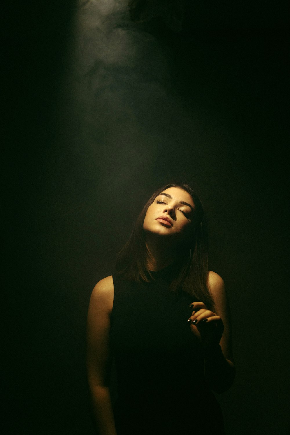 a woman smoking a cigarette in the dark