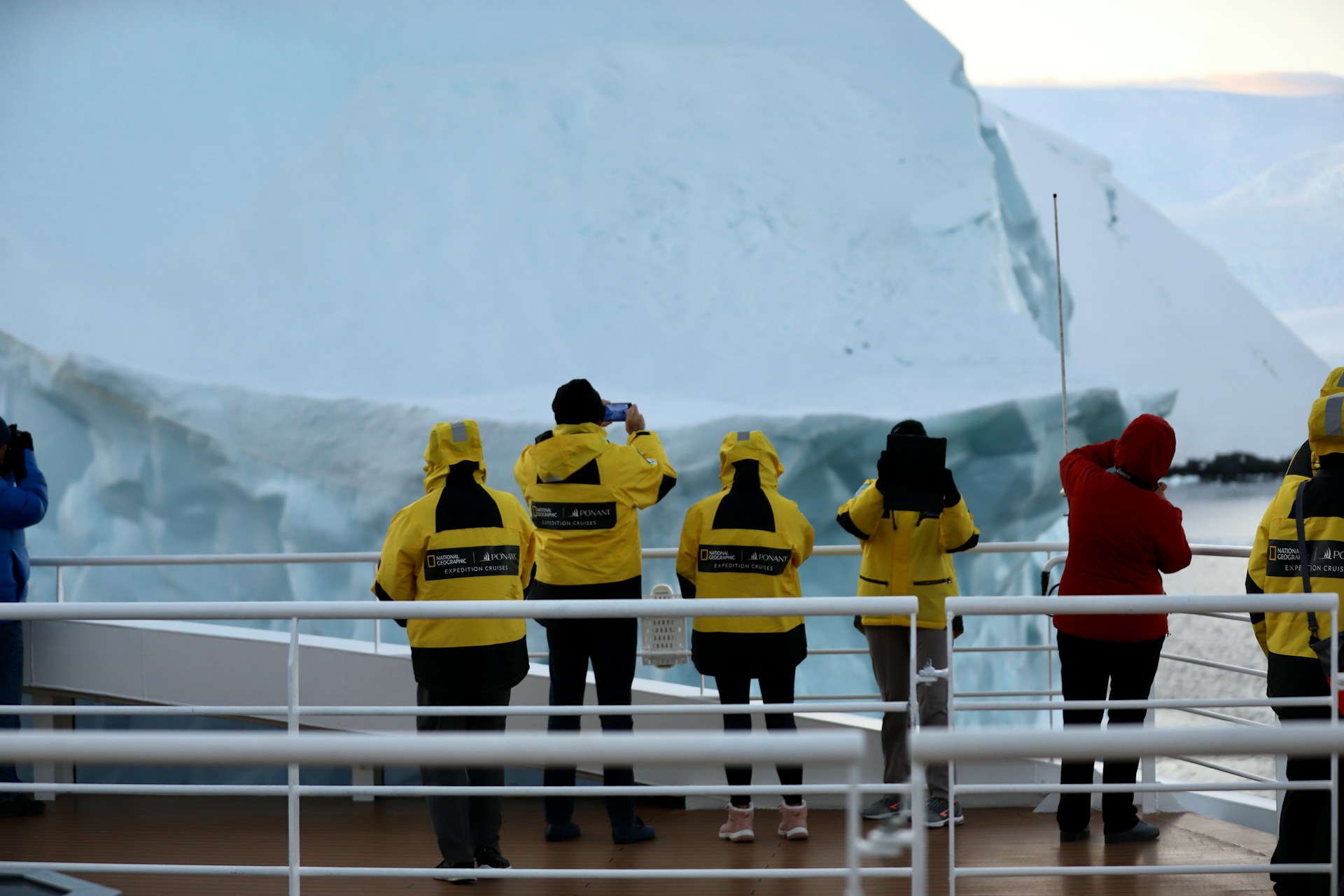 a group of people in yellow jackets standing on a boat