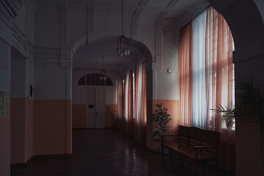 a long hallway with a bench in the middle of it