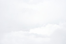 a group of people flying kites on a cloudy day
