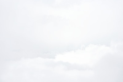 a group of people flying kites on a cloudy day