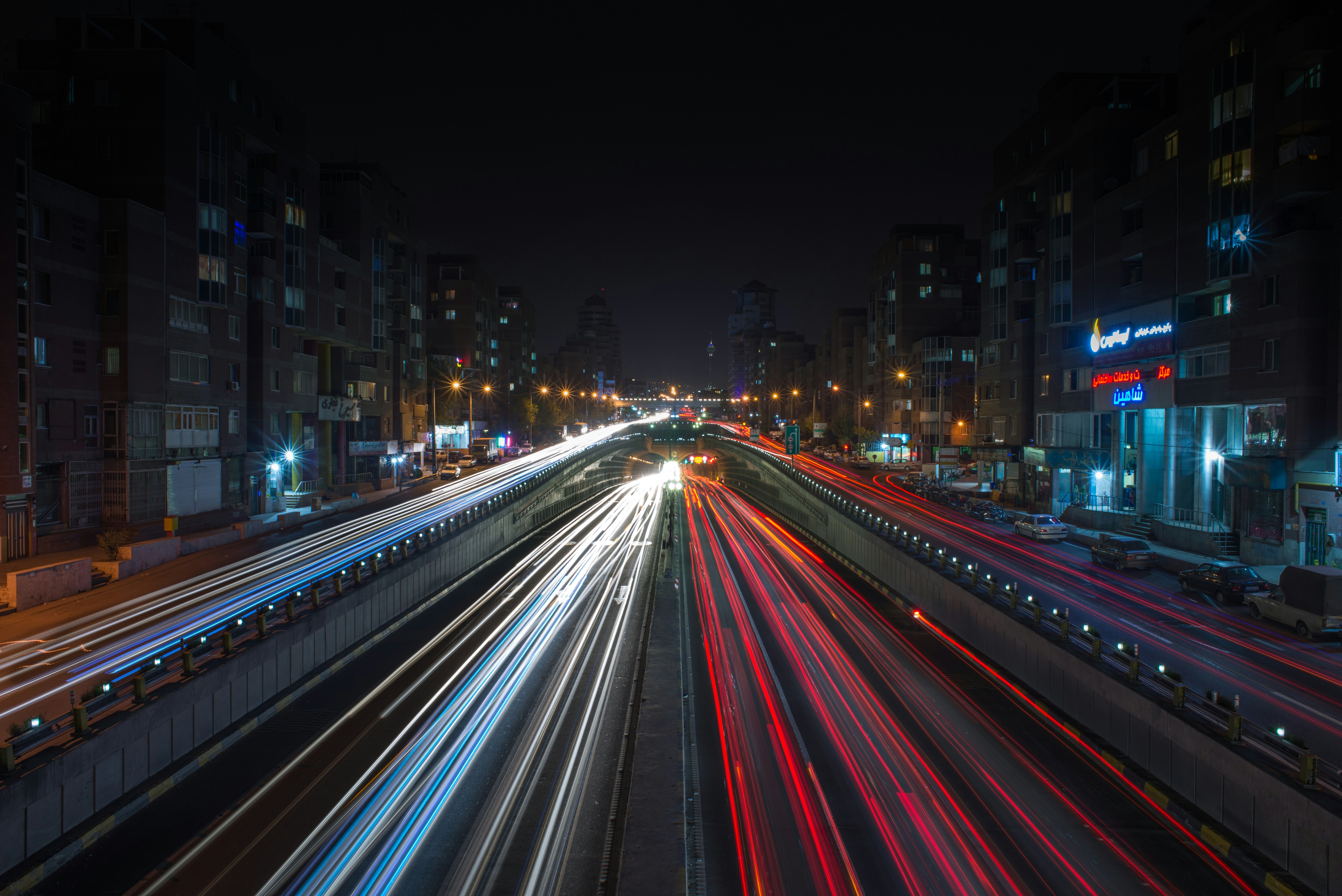 a city street filled with lots of traffic at night