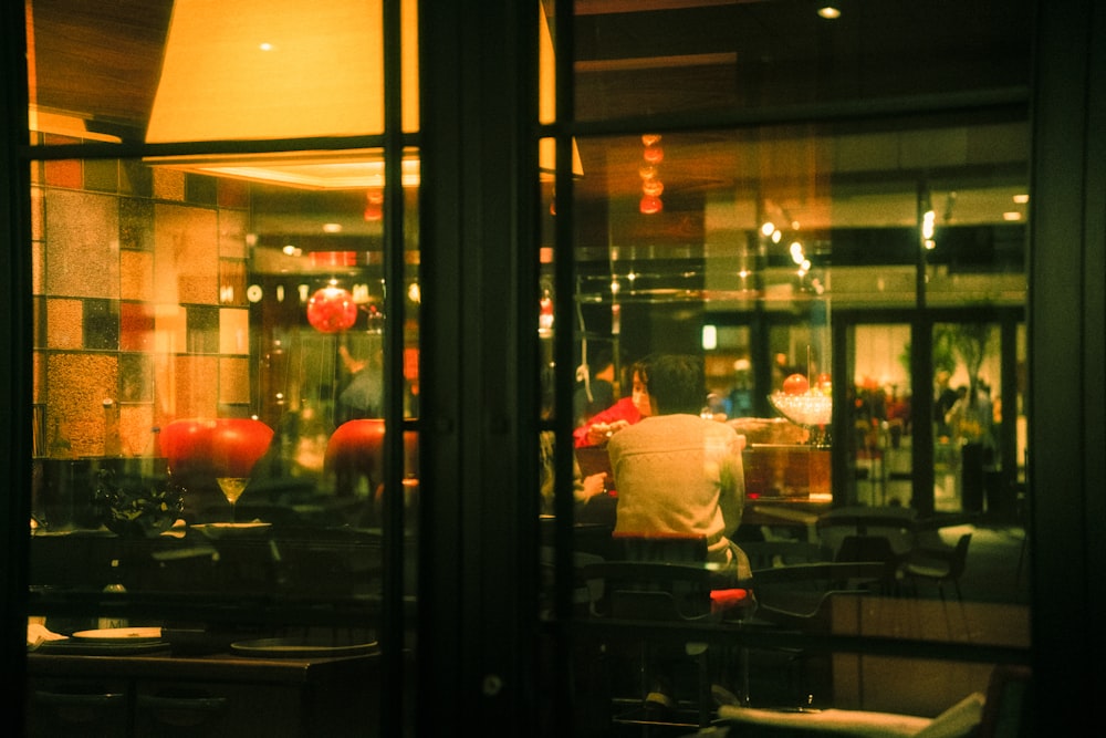 a view of a restaurant through a glass door