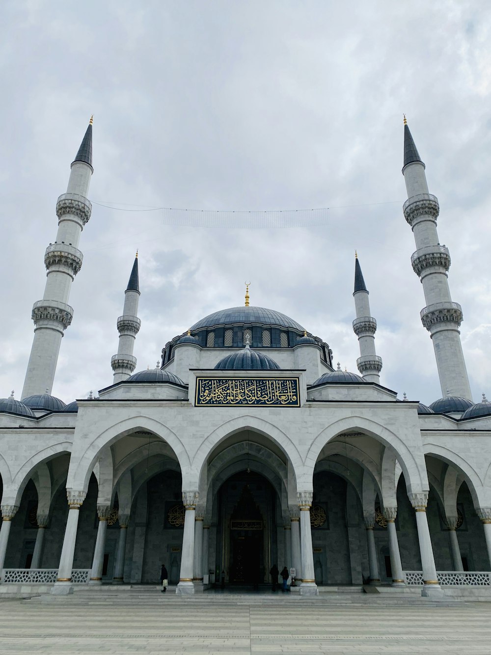 a large white building with two blue domes