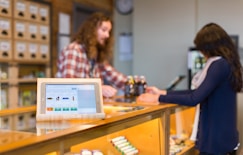 a woman standing at a counter in a store