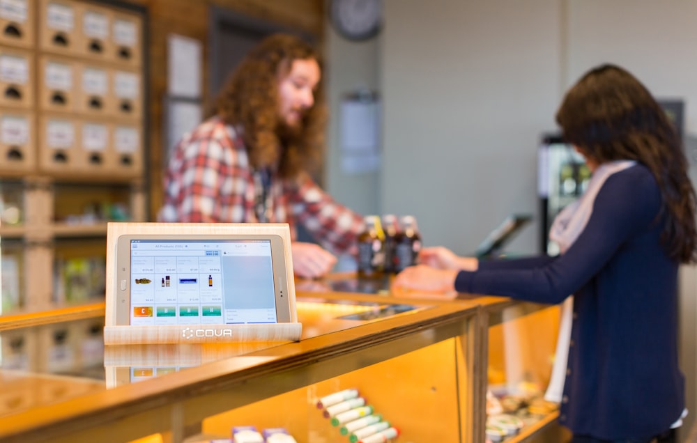 a woman standing at a counter in a store