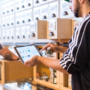 two men in a store looking at a tablet