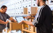 two men in a store looking at a tablet