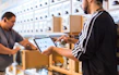 two men in a store looking at a tablet