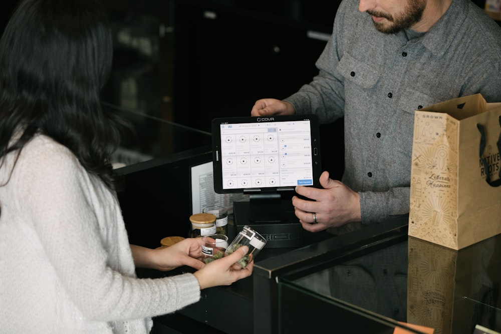 a man and a woman standing in front of a counter