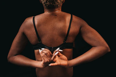 A joyful college girl adjusting her bra strap, radiating confidence.
