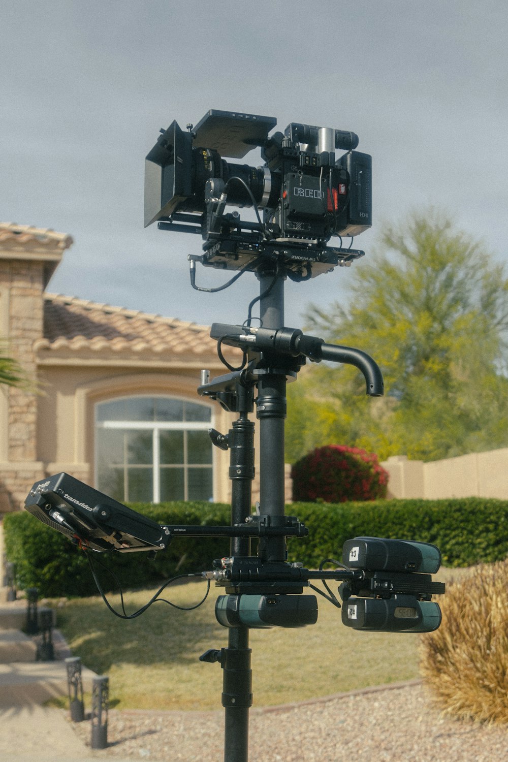 a camera set up on a pole in front of a house