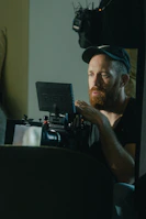 A male influencer filming a detailed beard styling tutorial with professional lighting.