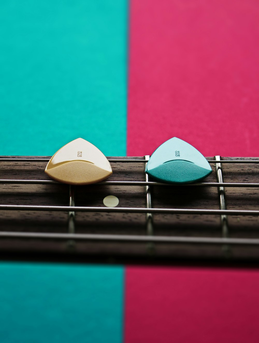 a close up of a guitar fret with a guitar pick