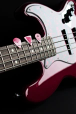 a red and white guitar with a black background
