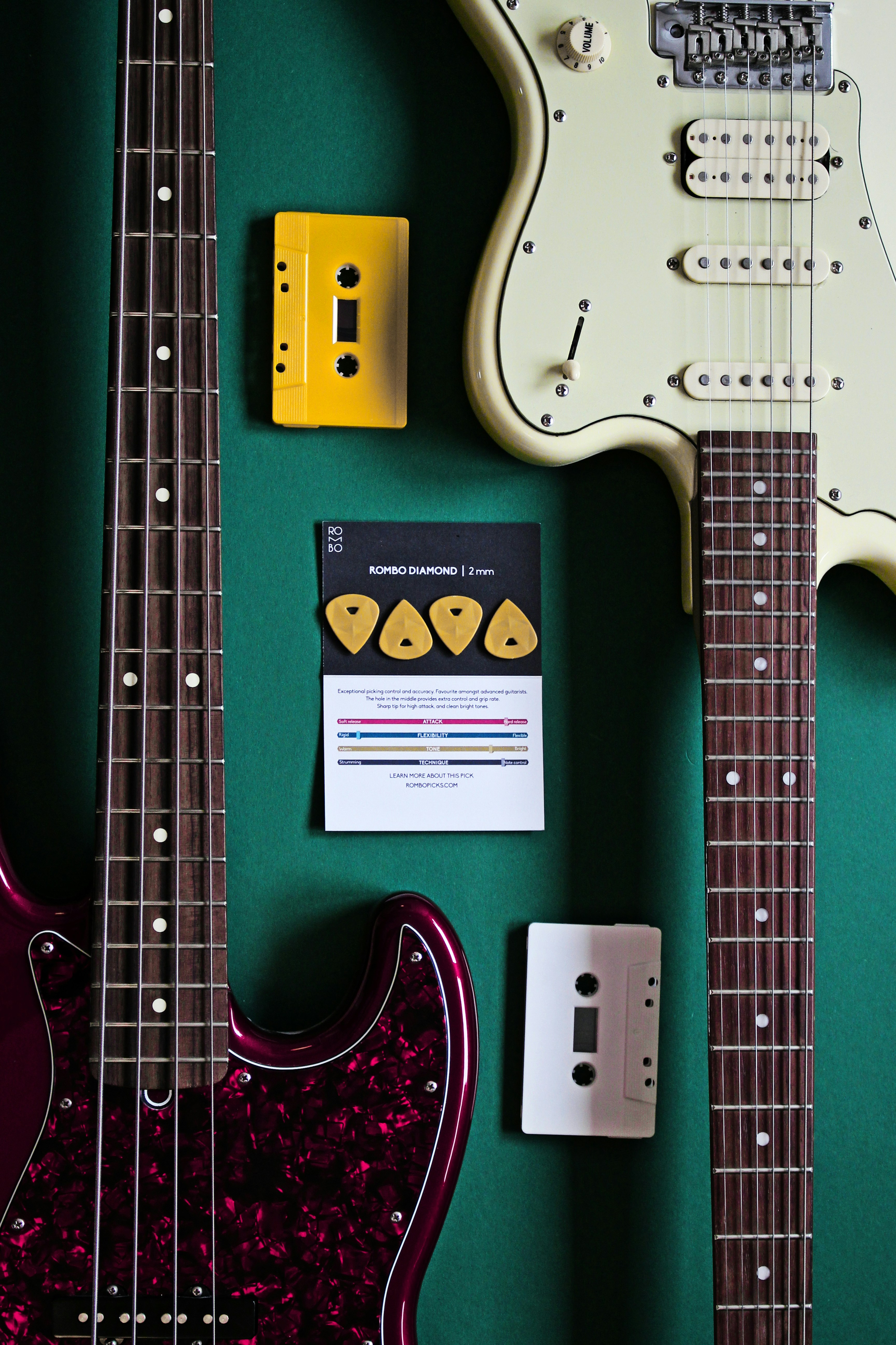 an electric guitar and other musical instruments on a green surface