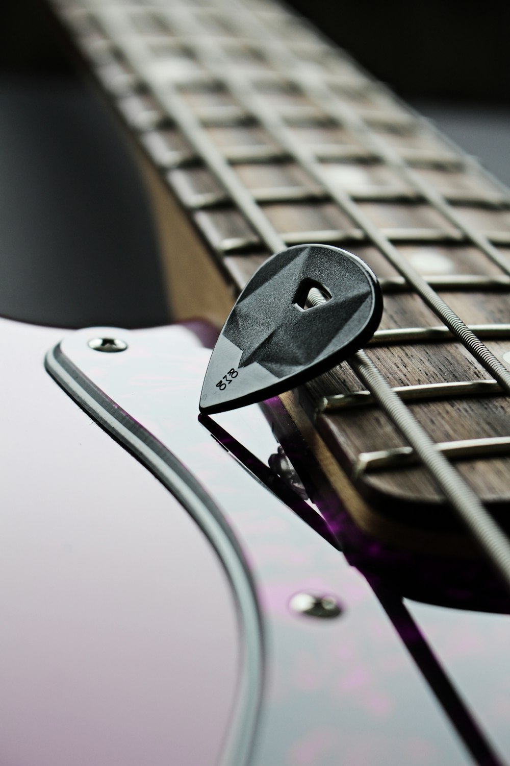 a close up of a guitar picker on a guitar