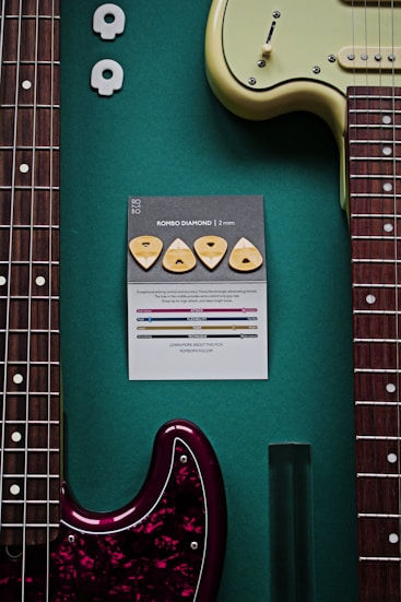 a guitar and a note on a green surface